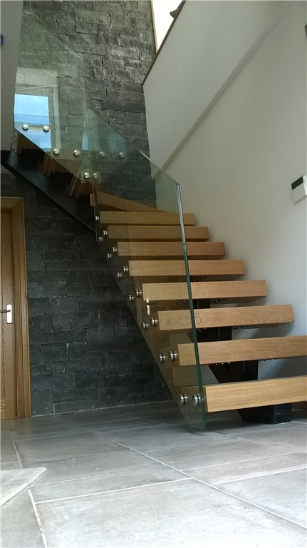 Staircase with metal spine & plate glass balustrade. Gallery Image
