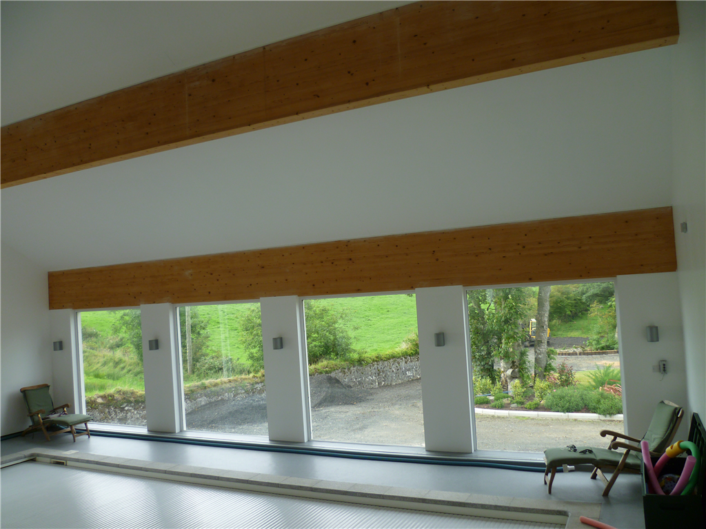 Large glulam beams, supporting roof structure of private swimming pool outside Ballycastle. Gallery Image