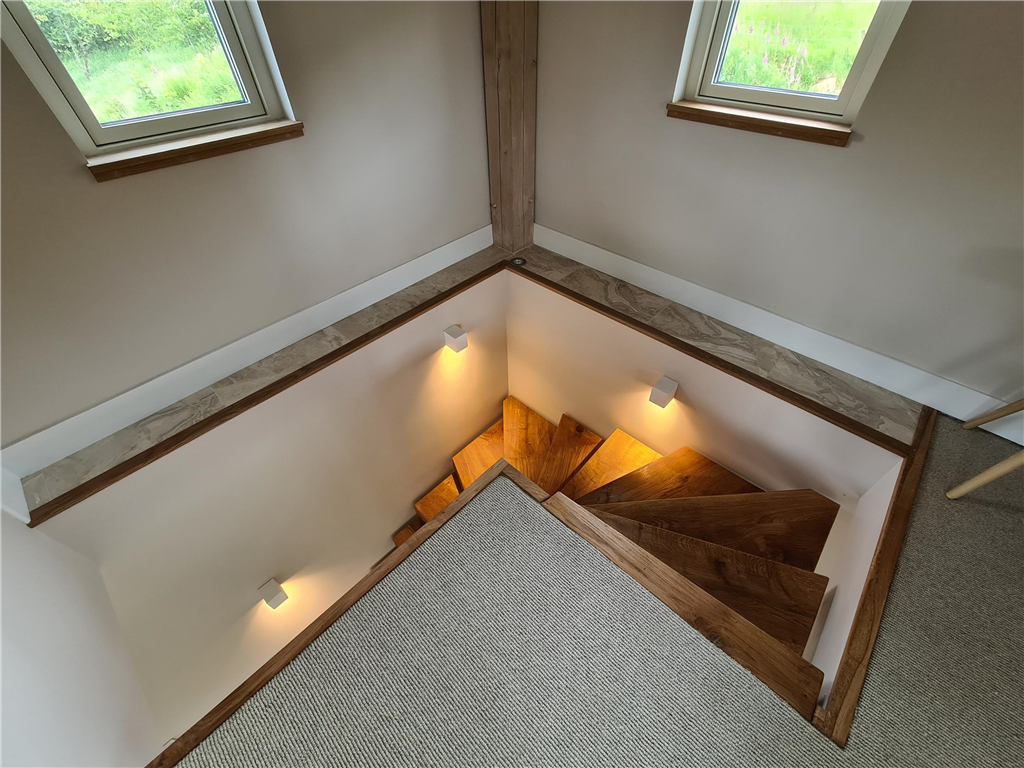 Curved staircase with recessed lighting Gallery Image