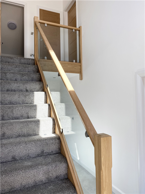 home staircase renovation complete with glass infill and timber top rail Gallery Image